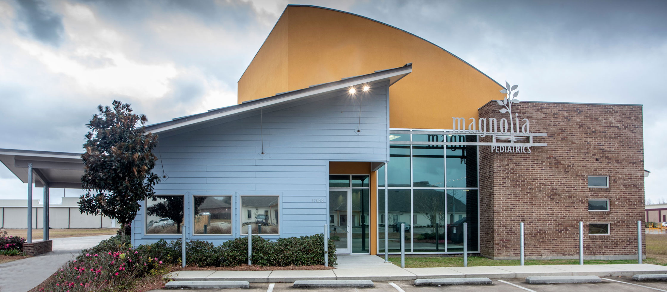 Siding, brick, stucco, and glass storefront exterior