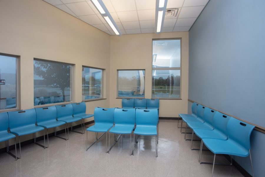 Waiting room with bright blue chairs and view to the outside