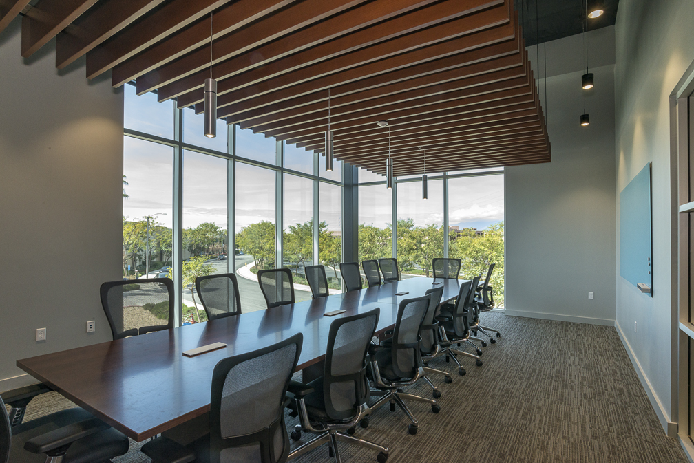 Conference room with large table and windows.