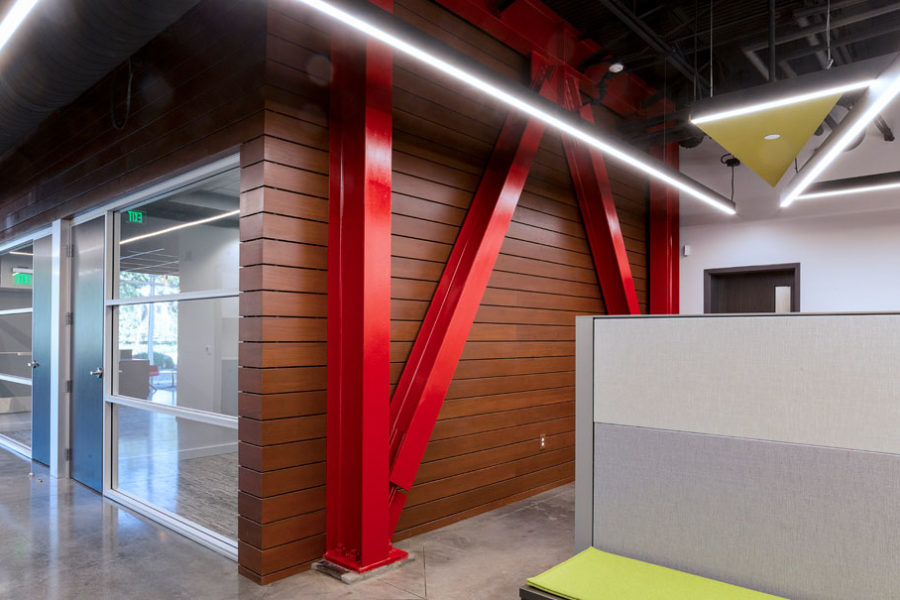 Redwood siding surrounding private meeting rooms with red painted structure