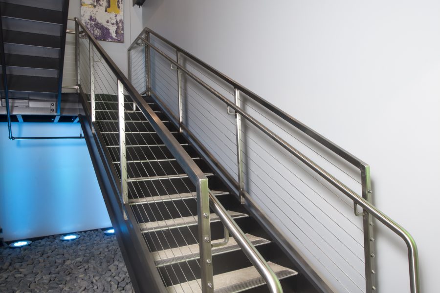 Open stairwell with colored lighting and artwork