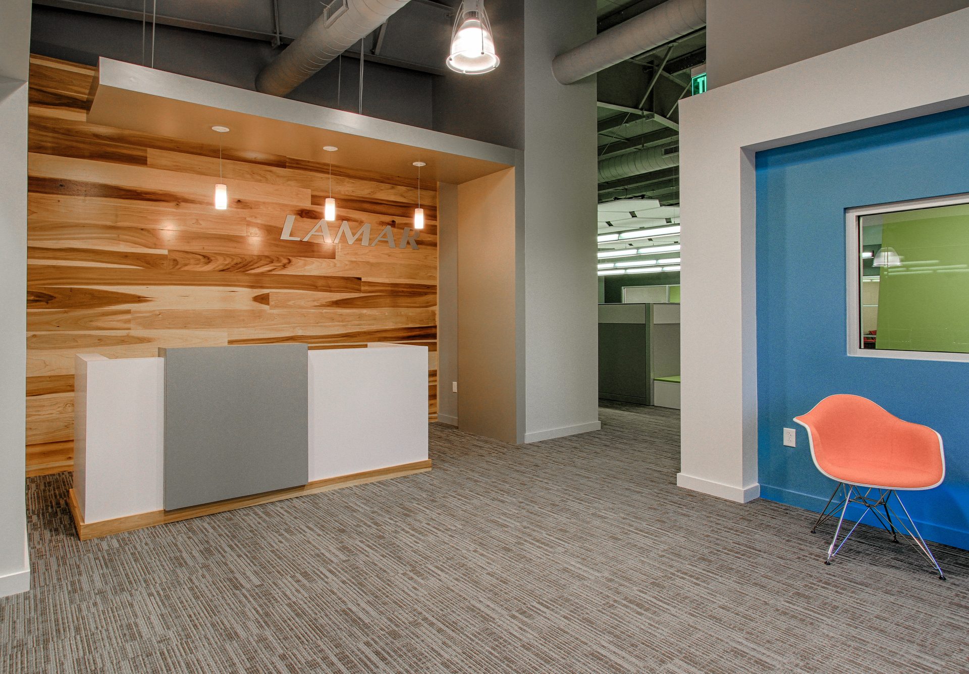 Reception area with wood accents and drop lights.