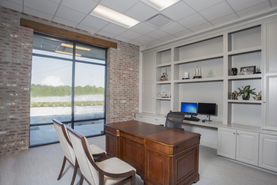 private office with large windows and exposed brick