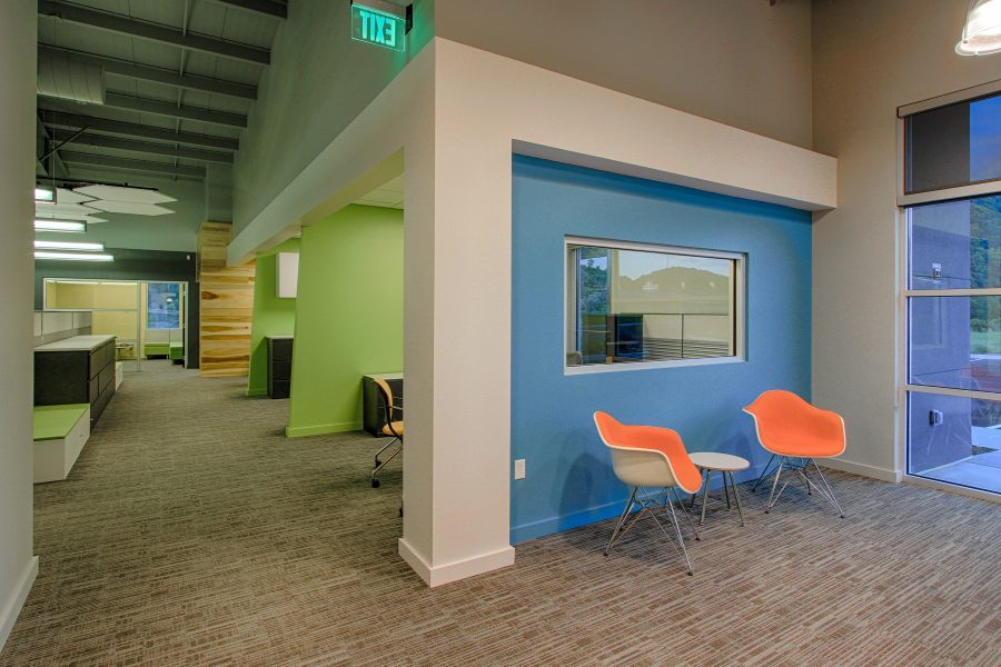 Open and bright lobby area with blue and green accent walls.