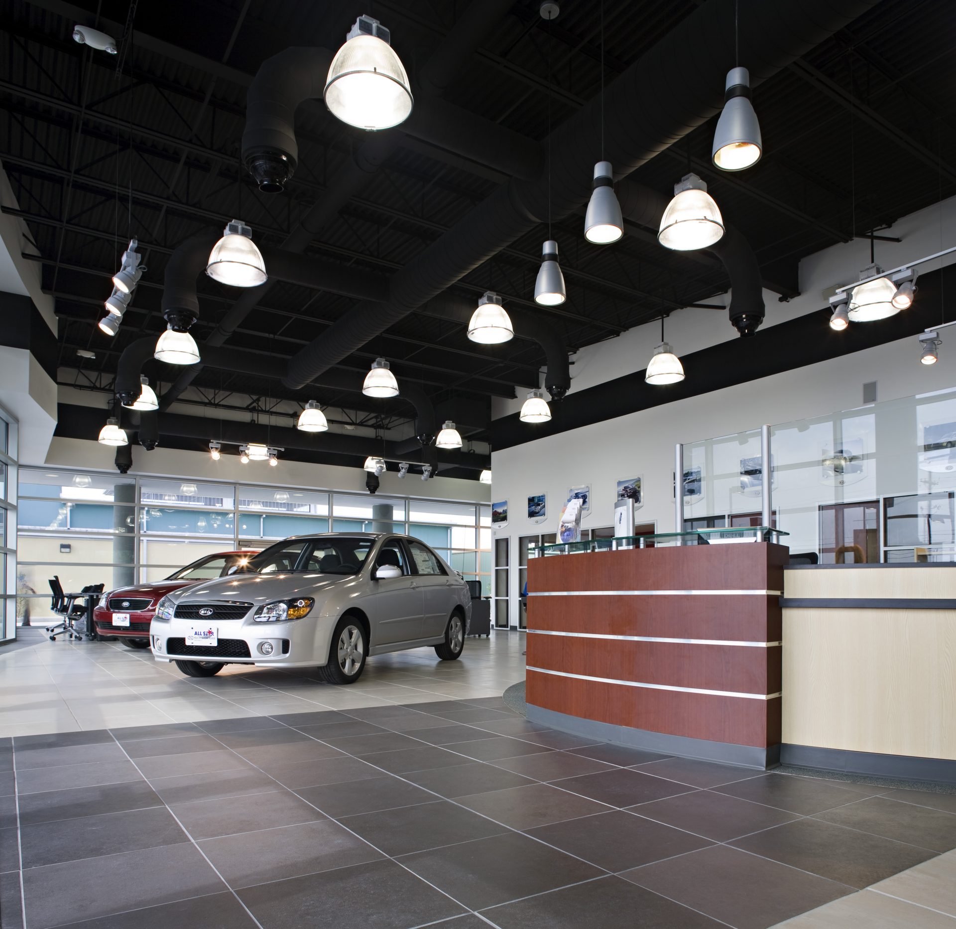 All Star Kia reception area with large, industrial-style lighting.