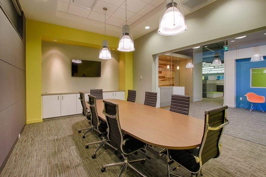 Conference room with table and bright accents.