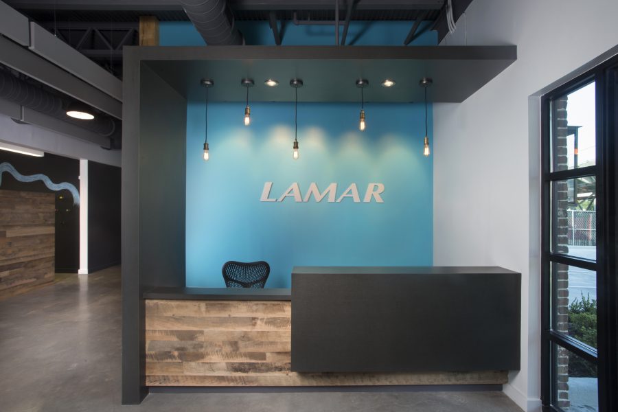 Lamar New Orleans reception area with bright blue wall and edison pendant lights