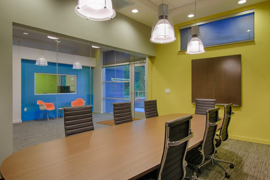 Conference room with bright yellow walls.