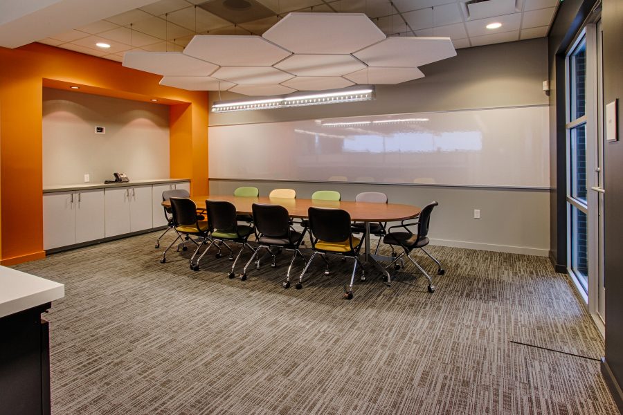Sales conference room with bright accents and hexagon ceiling tiles