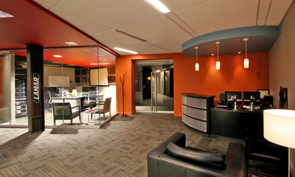 Orange accents at reception area with curved desk and glass walls