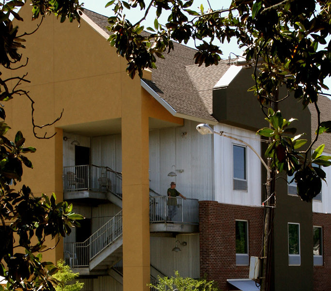 View of dorm building through trees