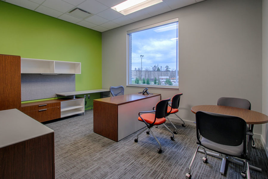 Interior of general manager's office with bright green accent wall