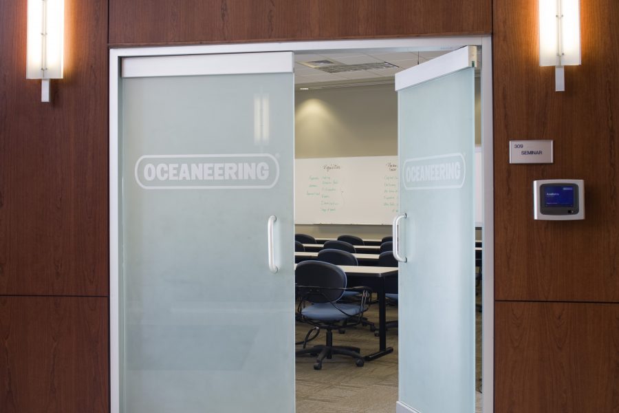 Frosted glass door details with lights at Oceaneering.