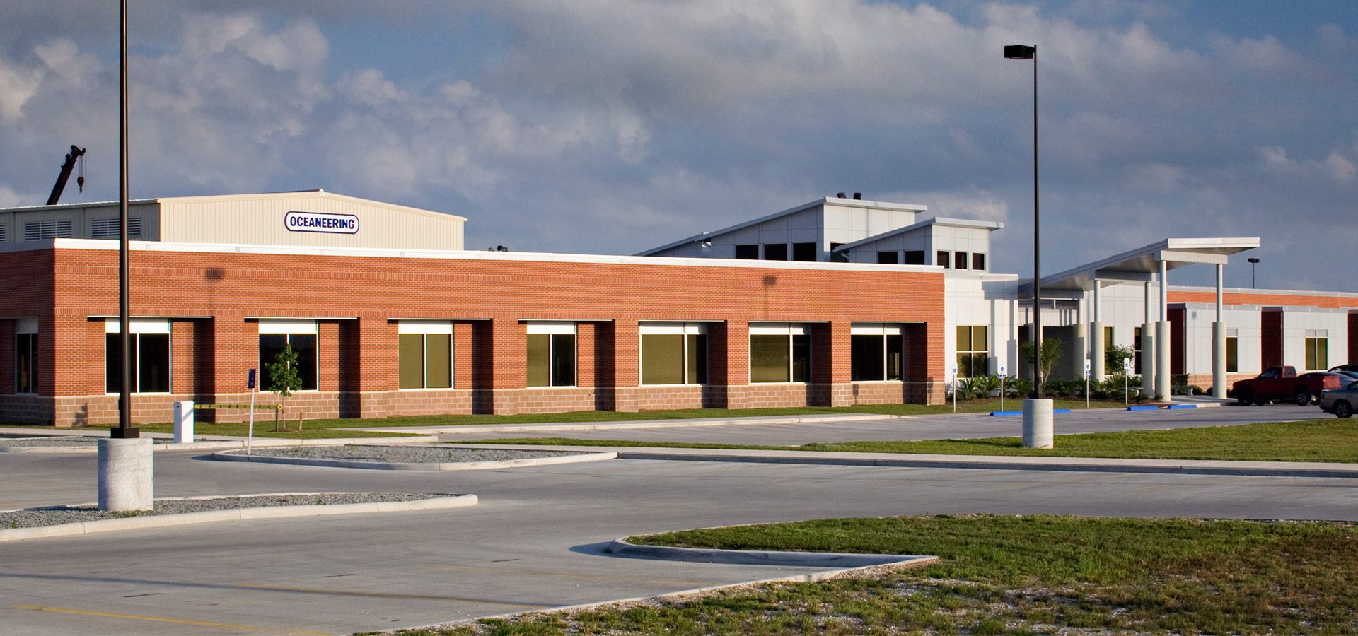 Exterior of Oceaneering with parking lot and signage.