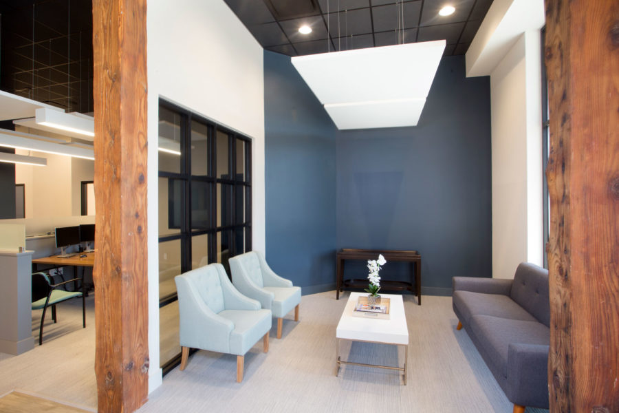 waiting room with wood columns and black framed storefront