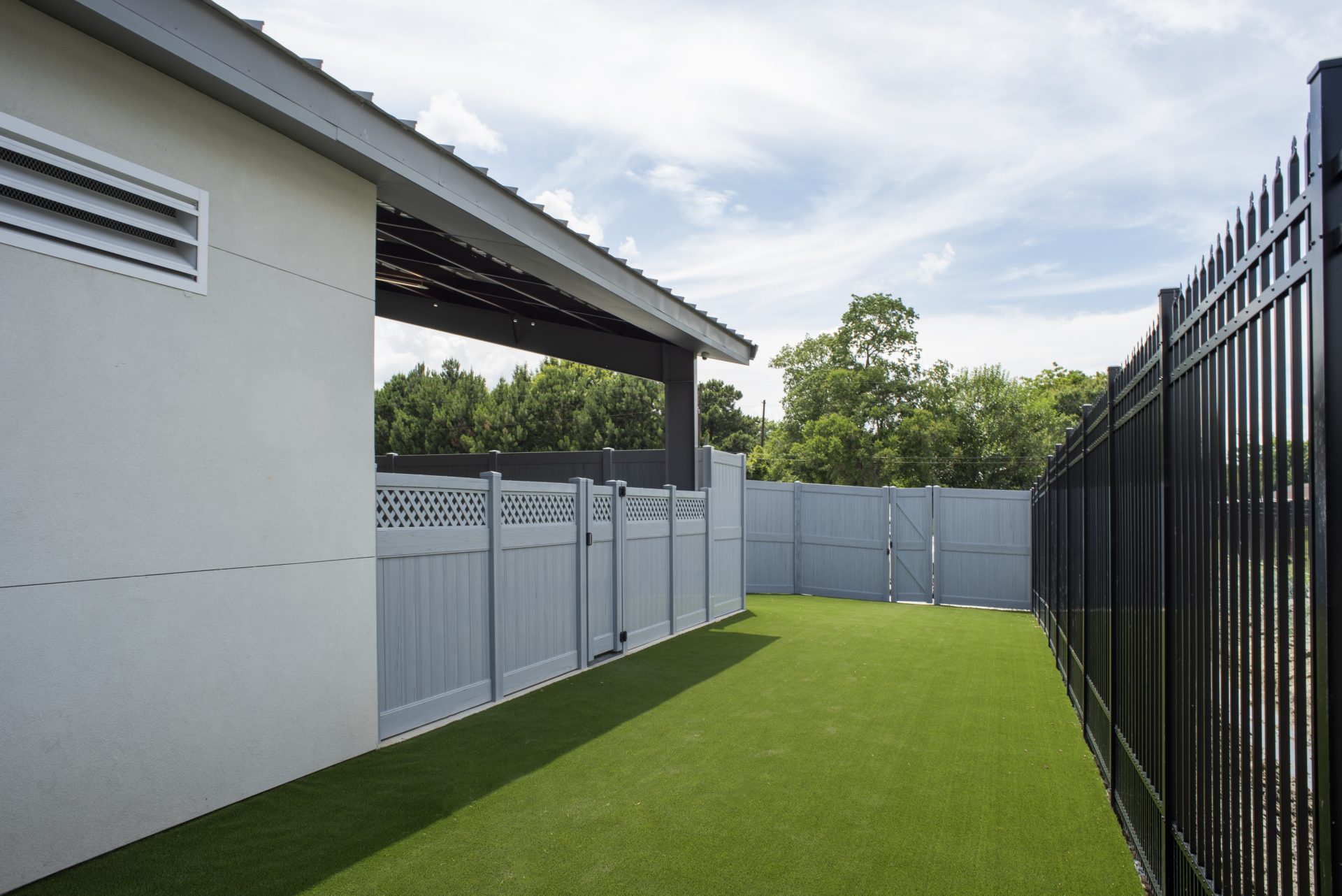 Outdoor turf and pet area at Lucky Dog Lodge.